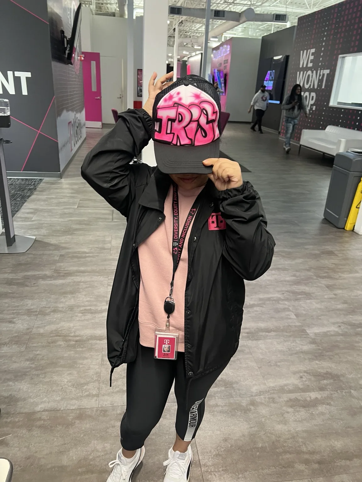 Guest wearing a personalized pink airbrush hat at the T-Mobile corporate event