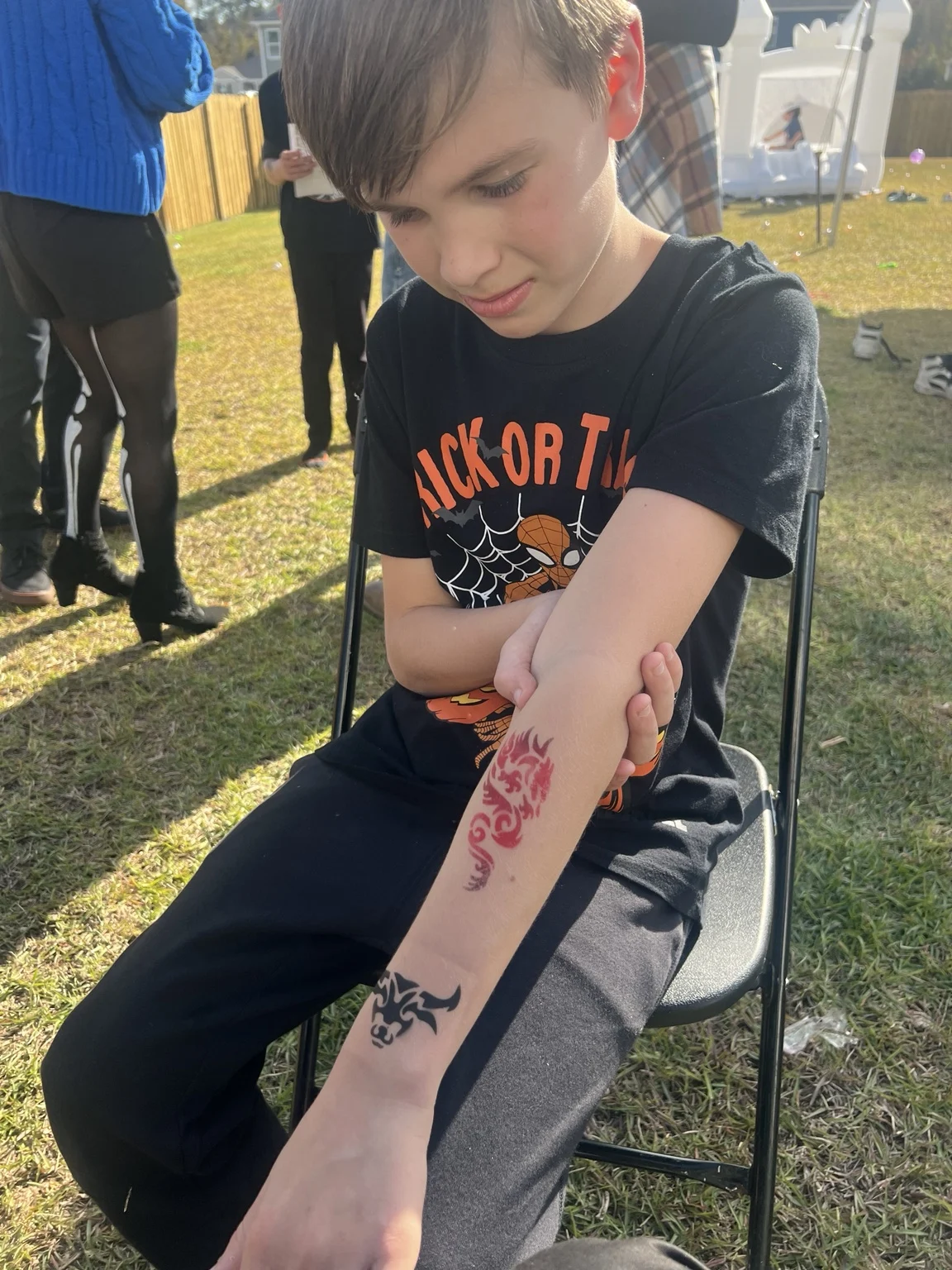 Young guest displaying temporary airbrush tattoos in Austin, Texas