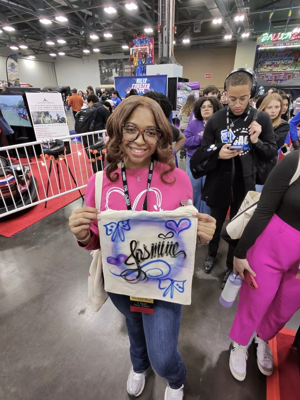 Student at a Birmingham college event holding a personalized airbrushed shirt