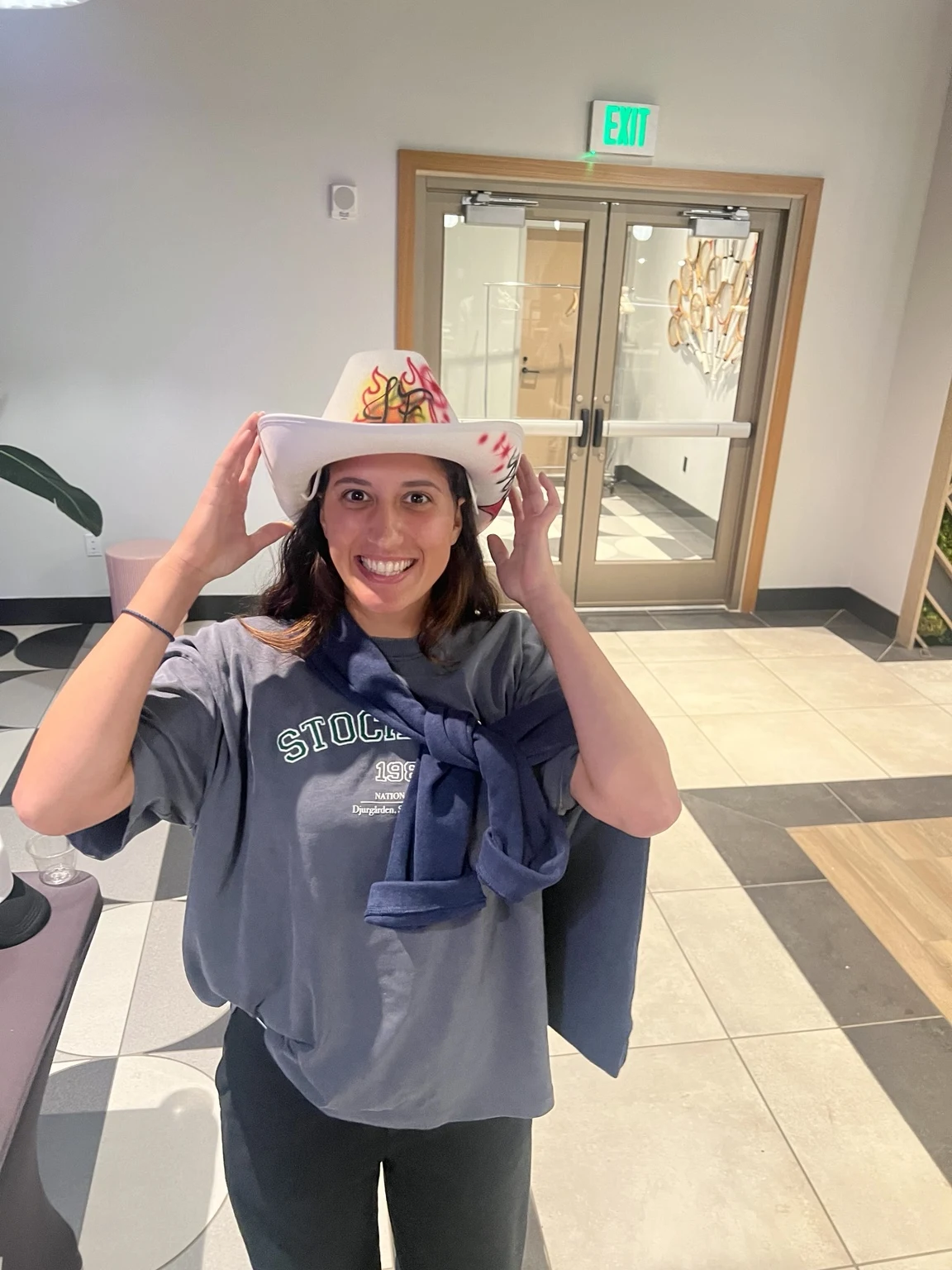 A player trying on a custom hat at the professional tennis tournament in Charleston, South Carolina