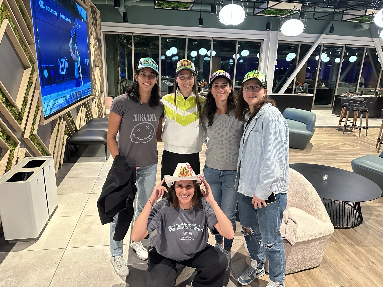 Professional tennis tournament participants with custom airbrushed hats in Charleston, South Carolina