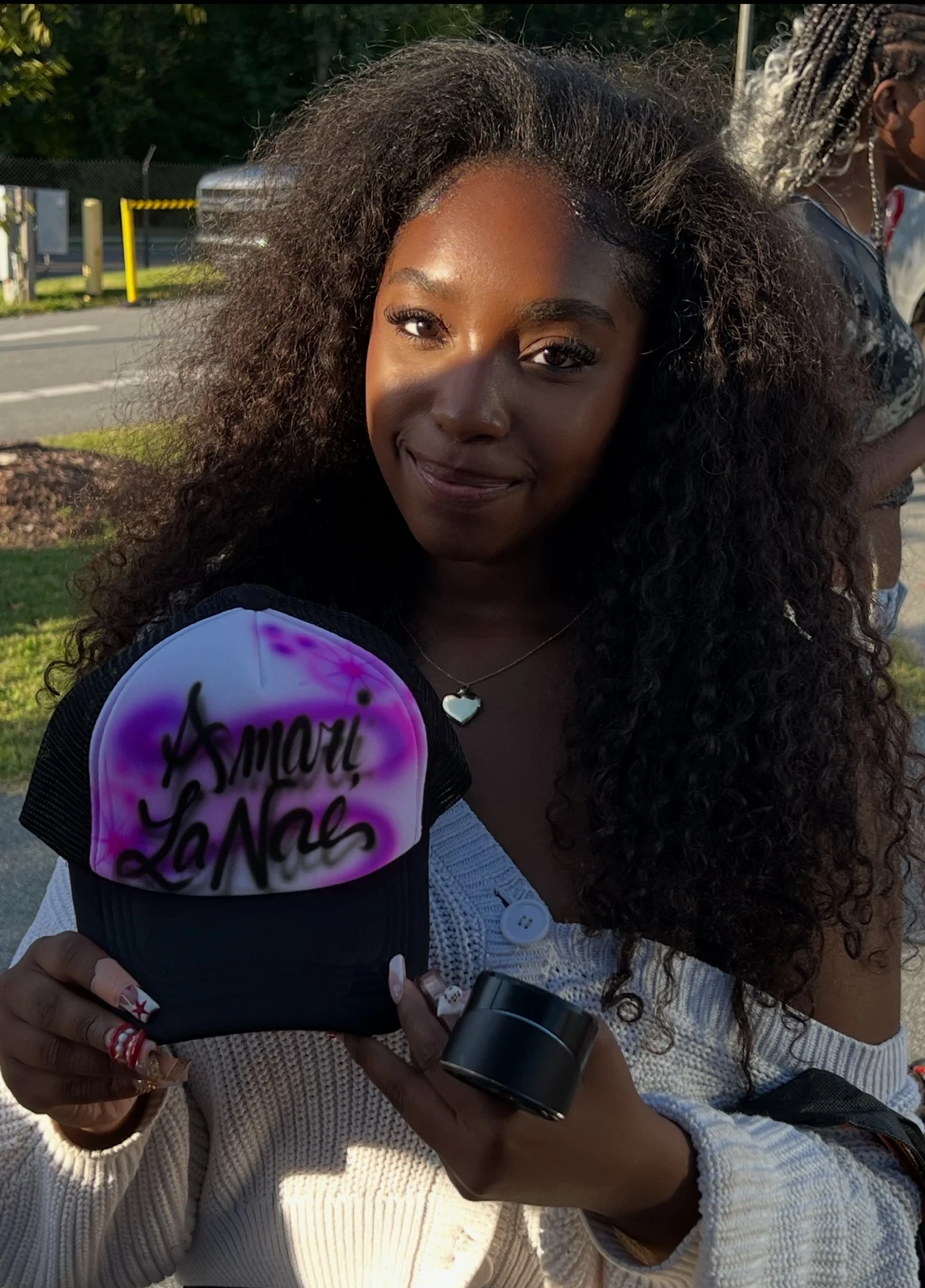 Florida A&M University student displaying a custom airbrushed trucker hat