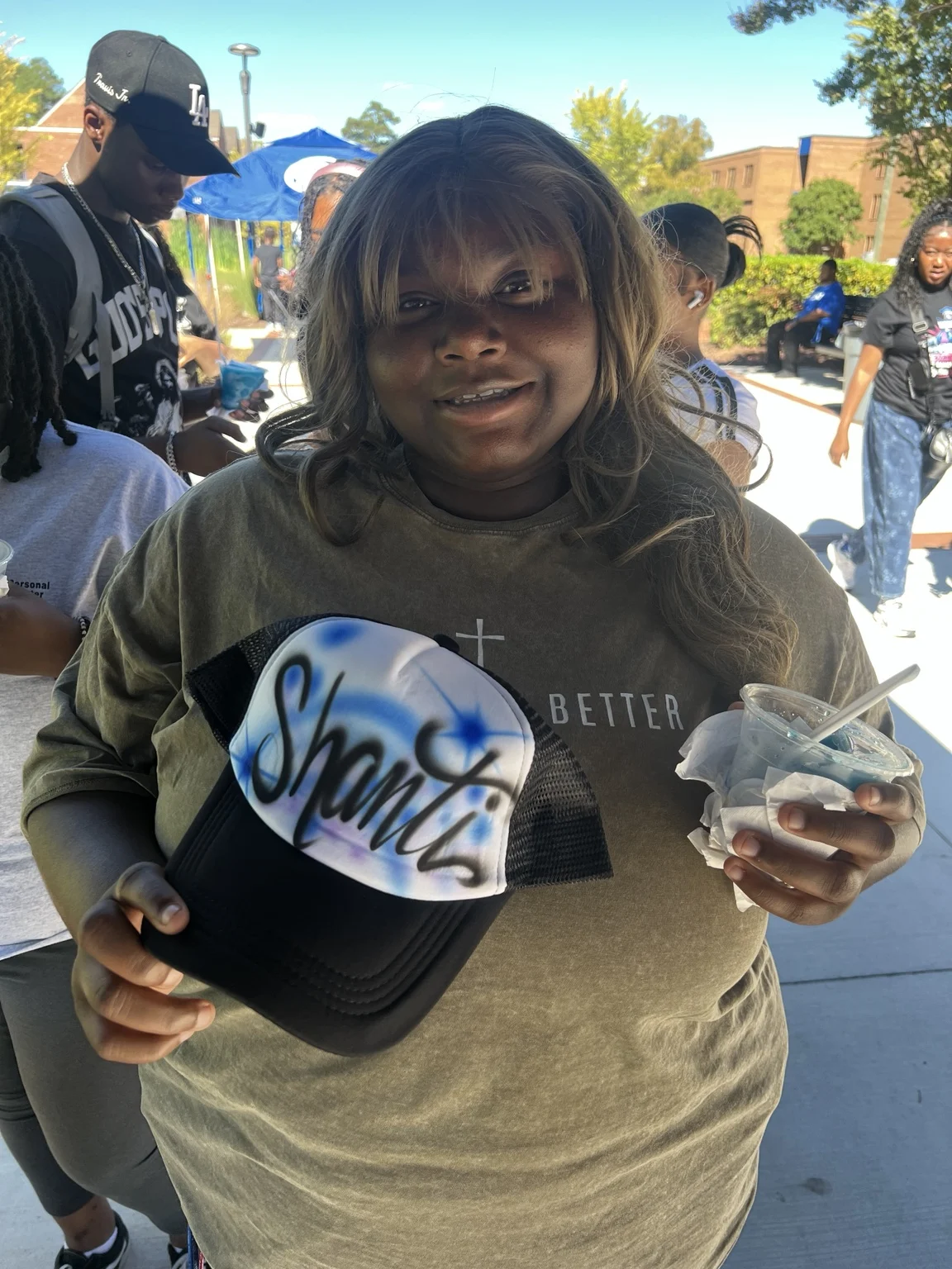 Guest showing a blue airbrushed name hat at Fayetteville State University homecoming