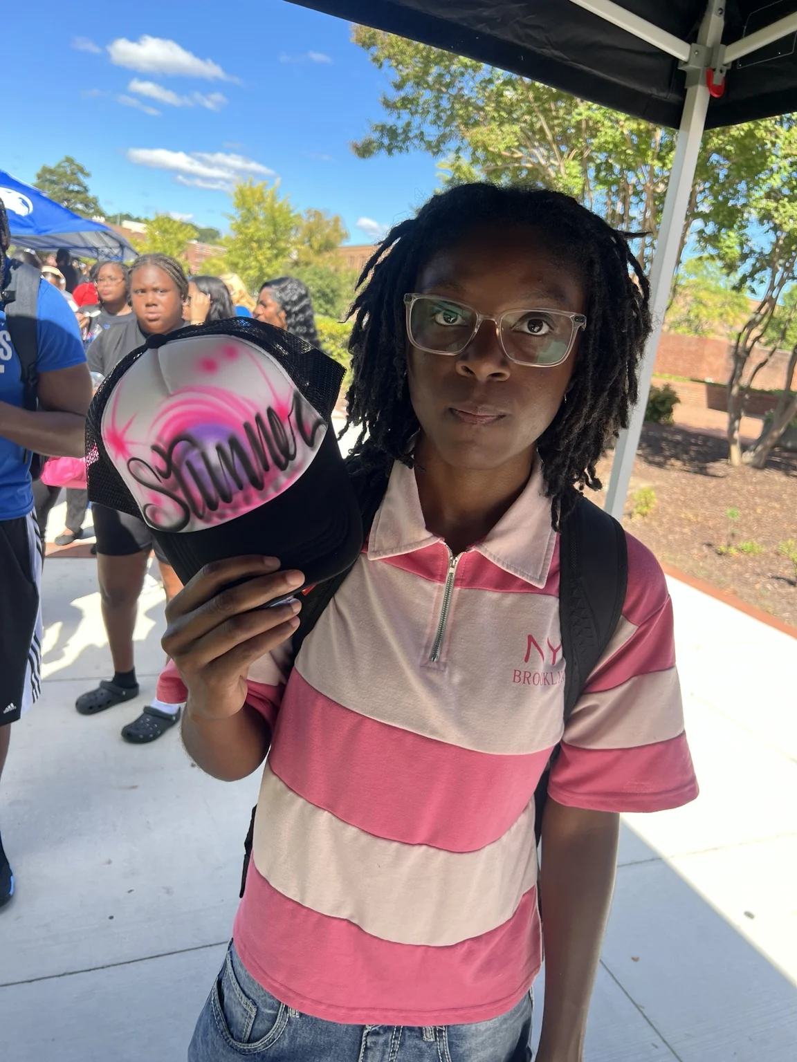 Guest displaying a pink airbrushed name hat at Fayetteville State University homecoming