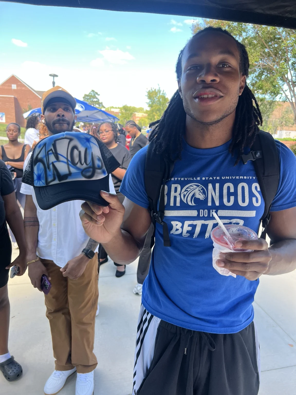 Guest in a Broncos shirt with a blue custom trucker hat at Fayetteville State University homecoming