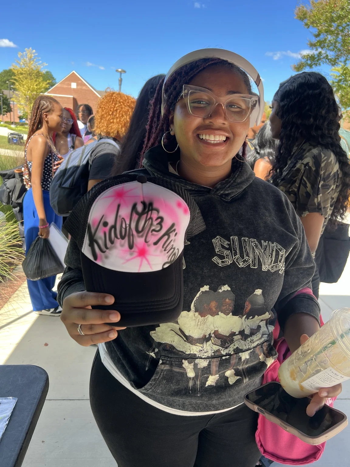 Guest smiling with a pink custom trucker hat at Fayetteville State University homecoming