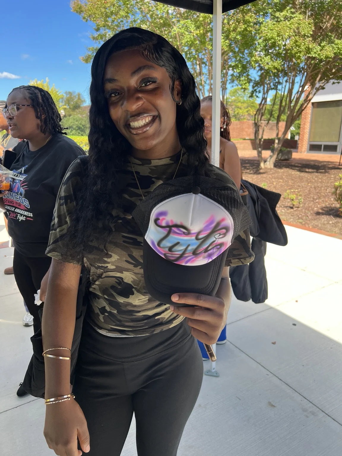 Guest displaying a pink and purple custom hat at Fayetteville State University homecoming