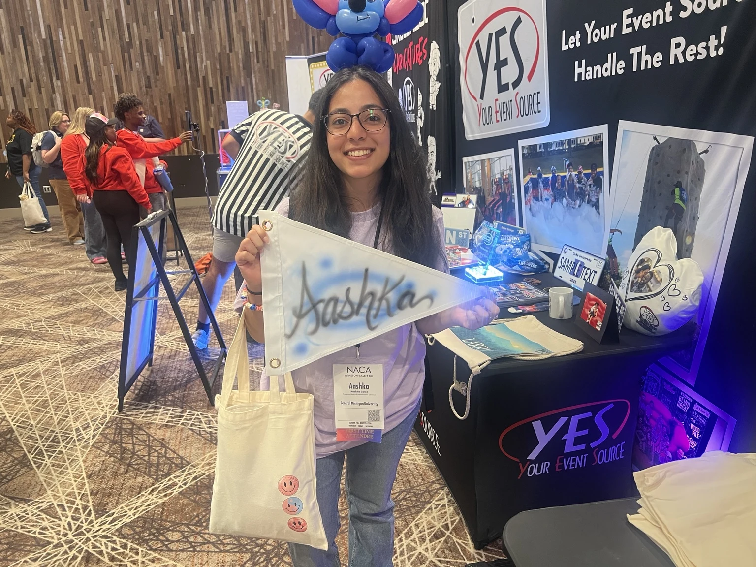 Michigan activation attendees displaying custom airbrushed trucker hats and a personalized bag
