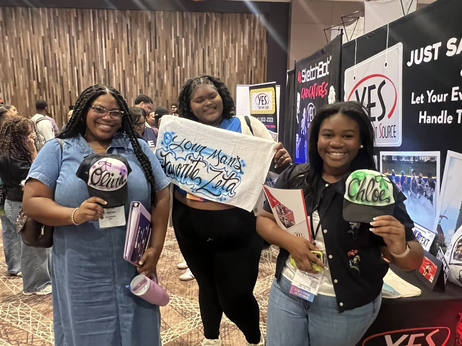 Michigan event guest holding an airbrushed name pennant and canvas tote bag