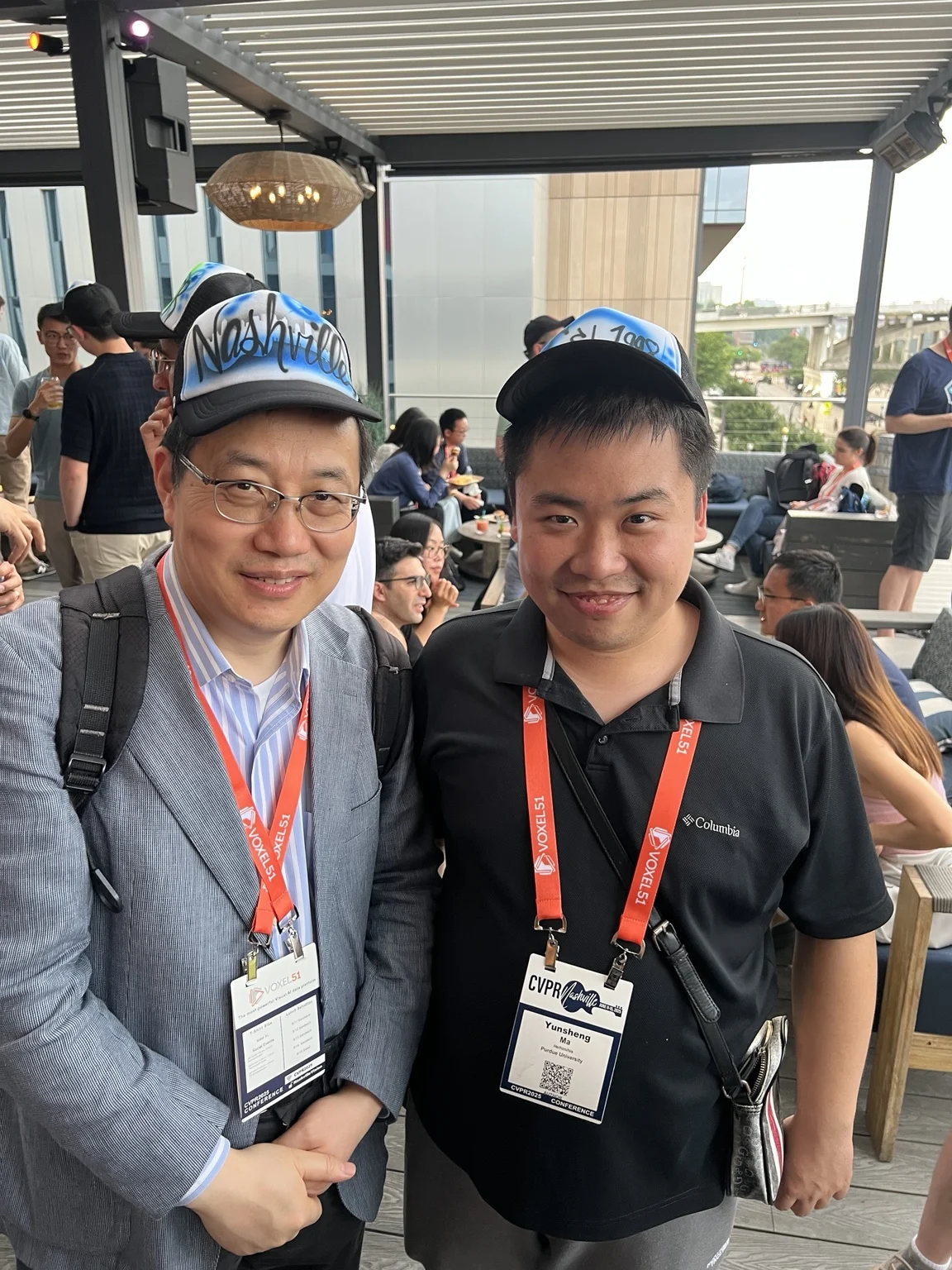 Two Nashville corporate event guests wearing custom hats in Nashville, Tennessee