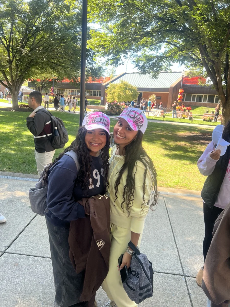 Guests posing in their custom pink airbrushed hats at Penn State