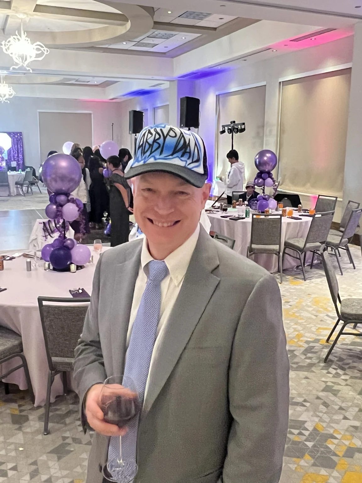 Guest wearing a blue and white custom airbrushed trucker hat at an event in Portland, Oregon