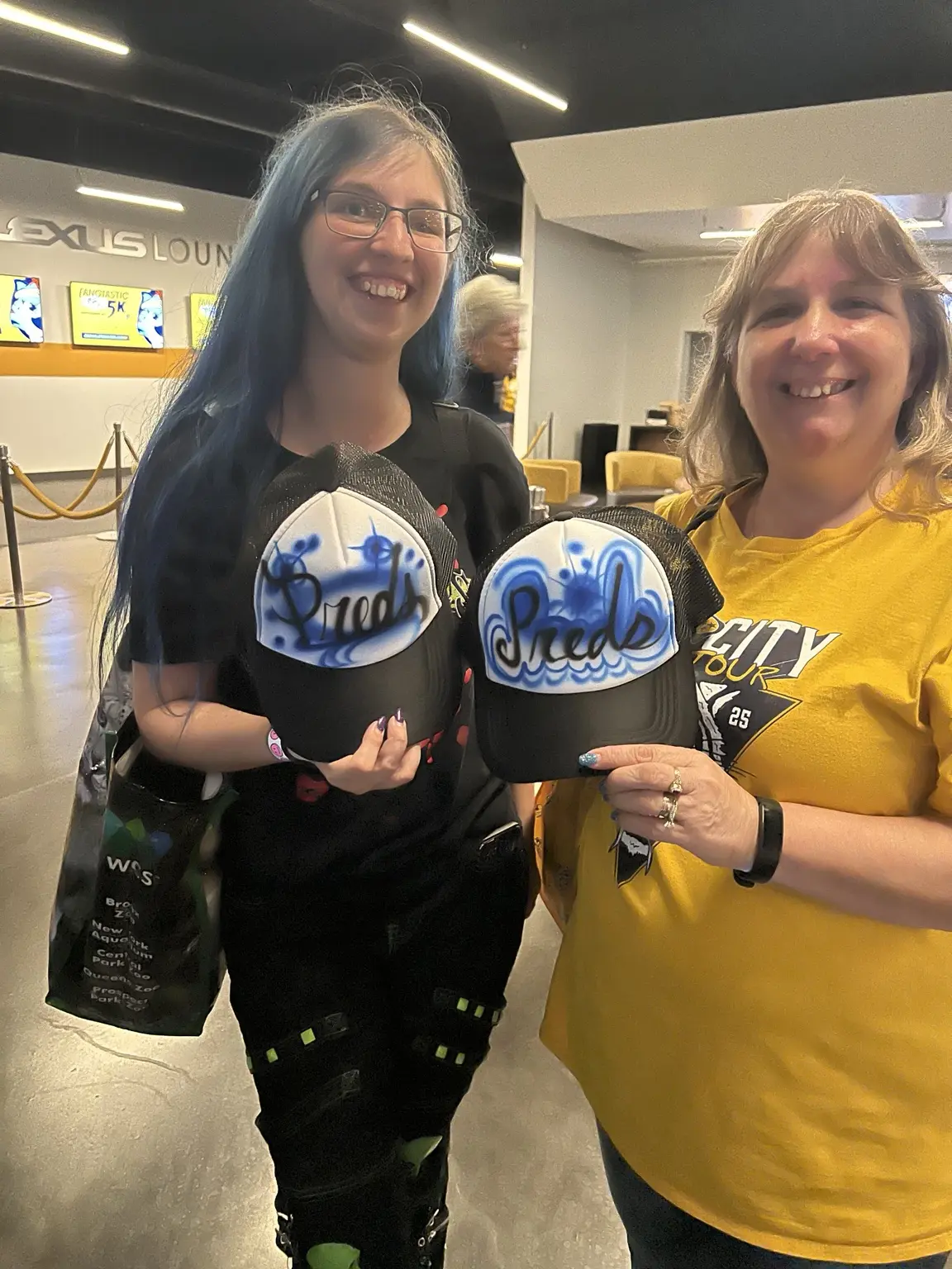 PwC event guests displaying three personalized airbrushed trucker hats