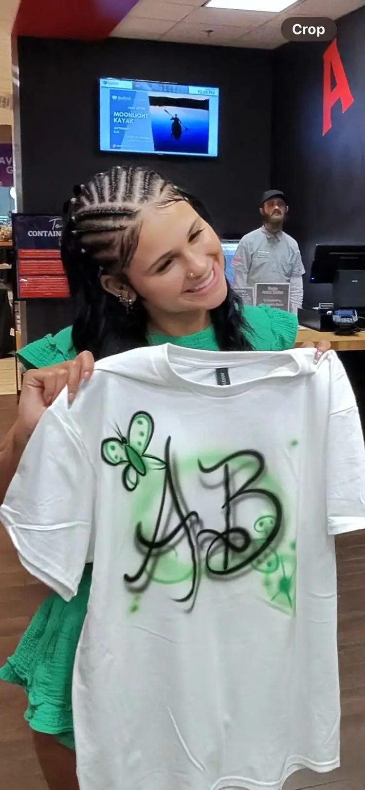Radford University student displaying a green and black personalized airbrush shirt
