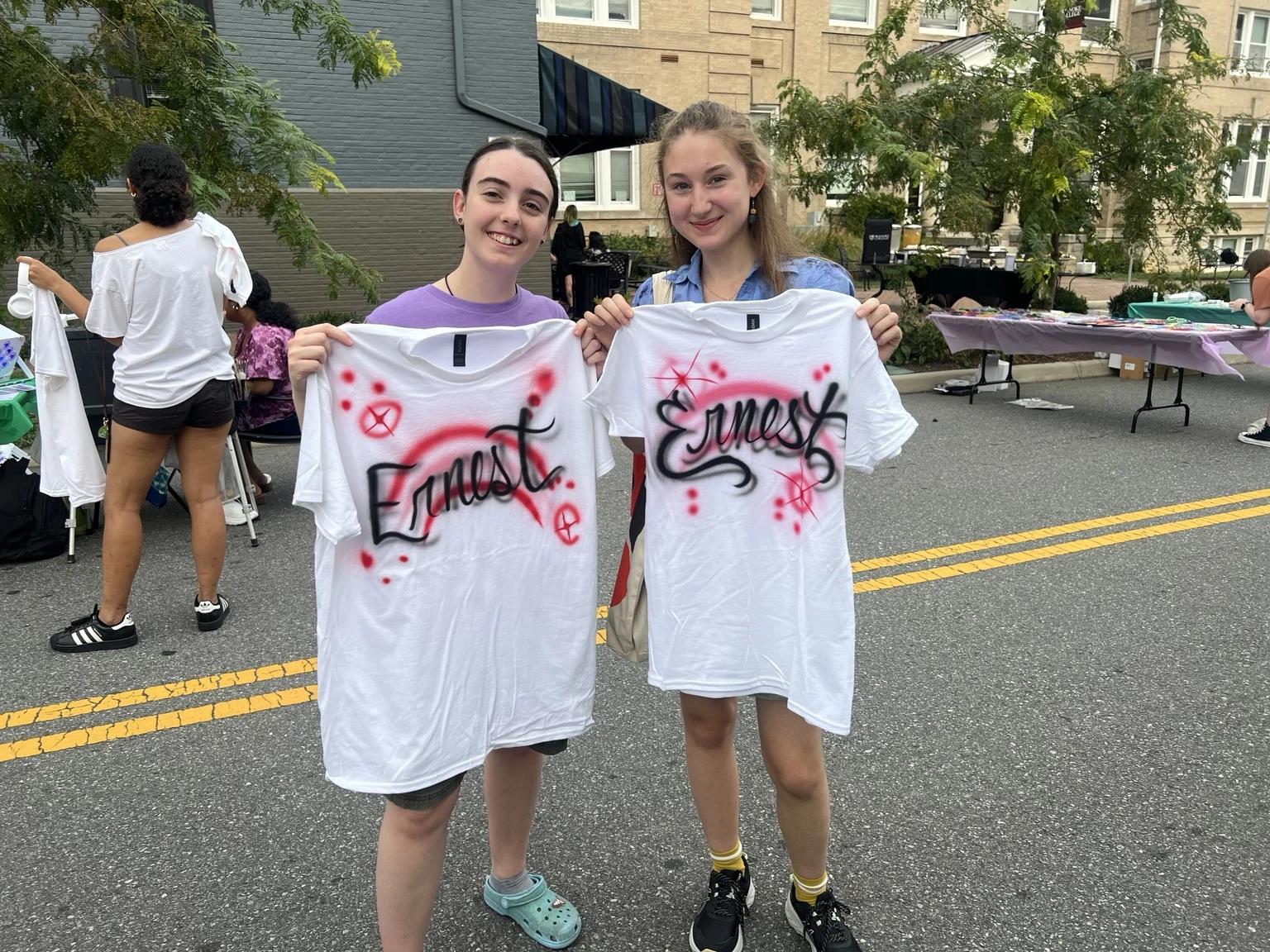 Students displaying personalized airbrushed shirts at Roanoke College Fall Festival in Salem, Virginia