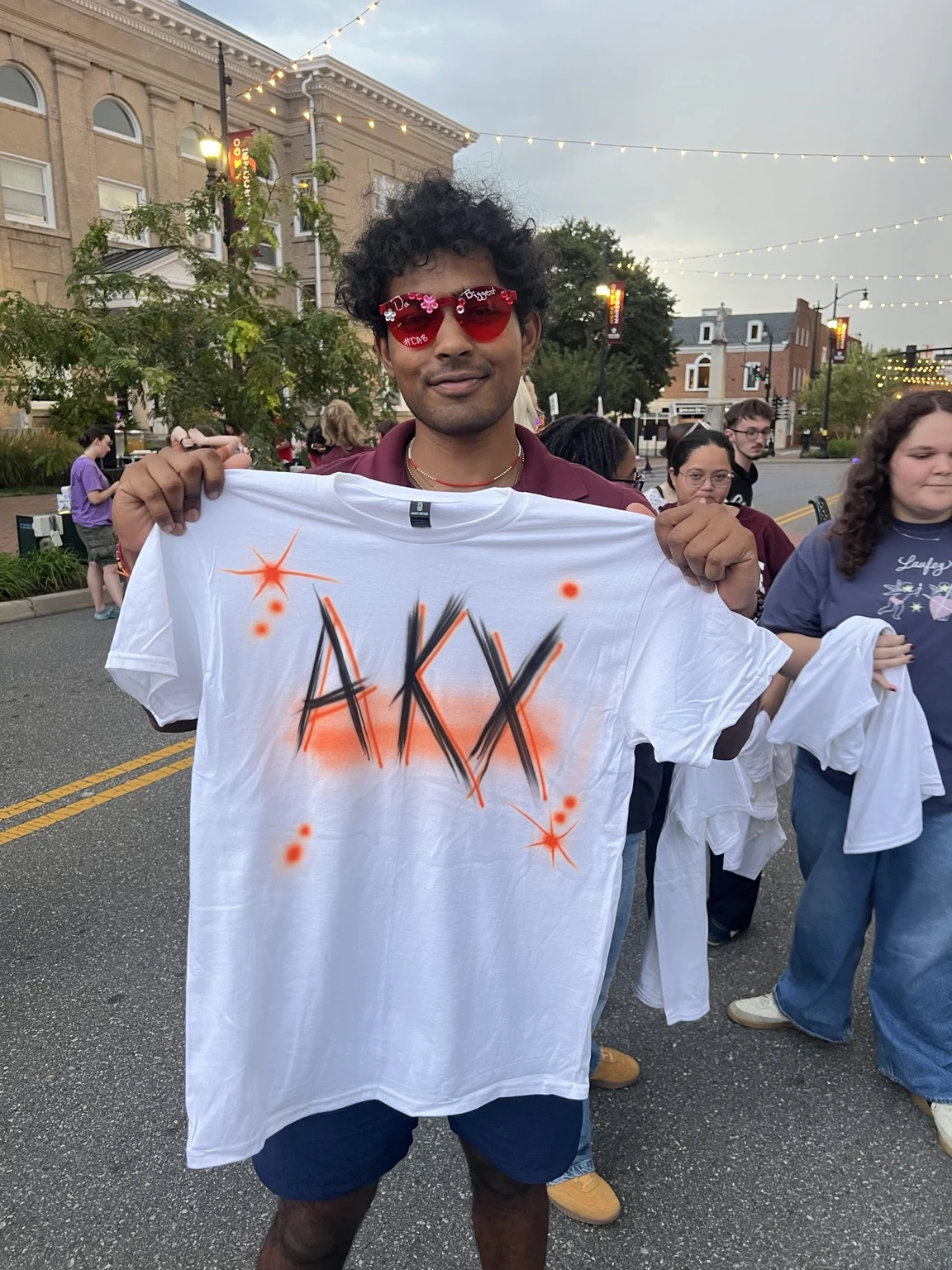 Students displaying personalized airbrushed shirts at Roanoke College Fall Festival in Salem, Virginia