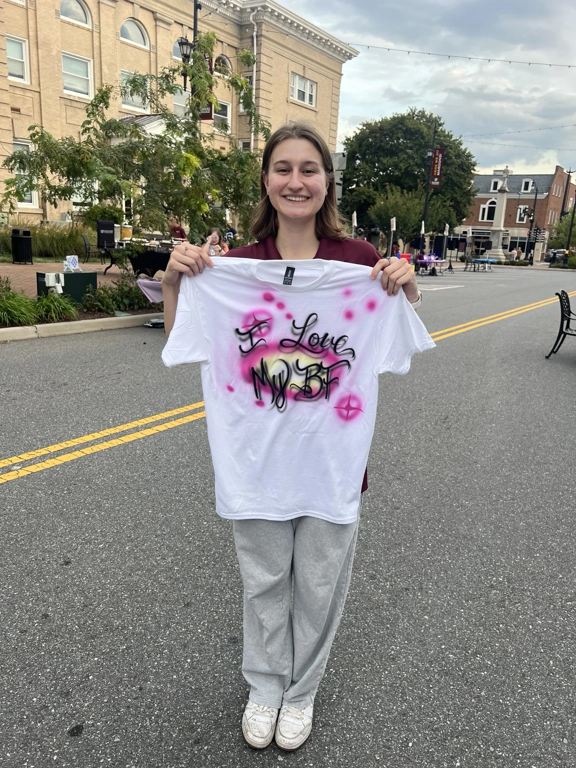 Students displaying personalized airbrushed shirts at Roanoke College Fall Festival in Salem, Virginia