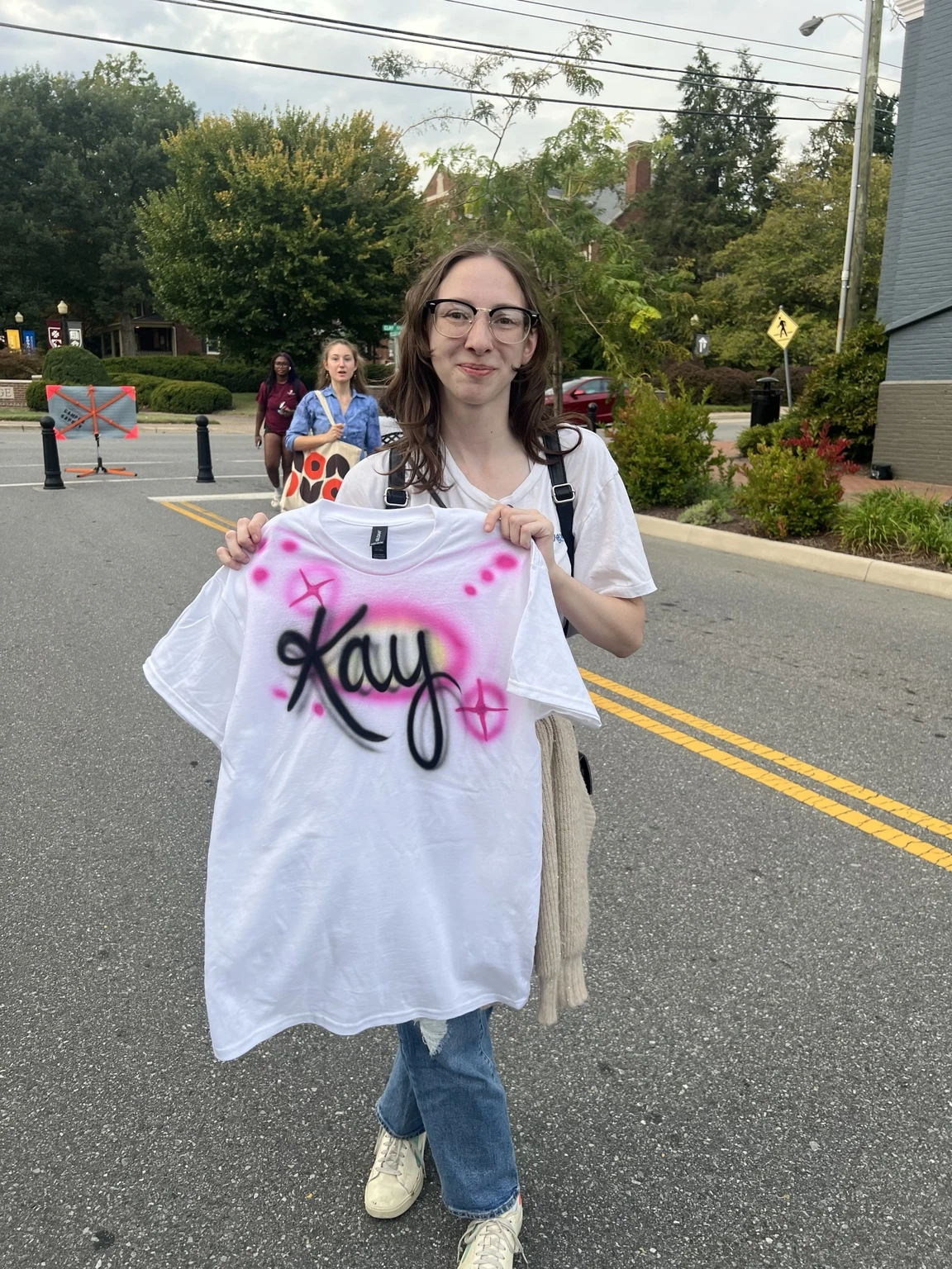 Students displaying personalized airbrushed shirts at Roanoke College Fall Festival in Salem, Virginia