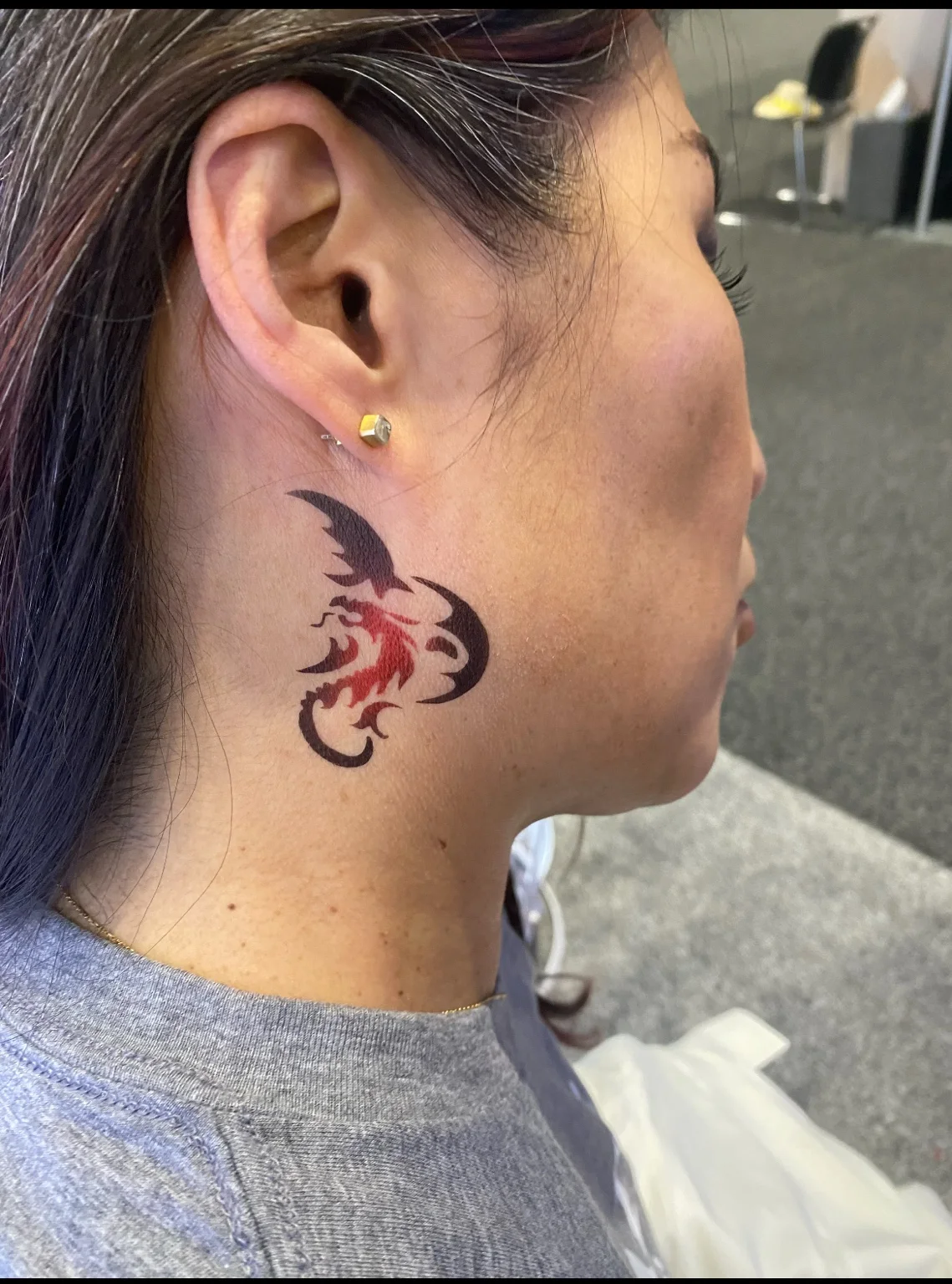 Decorative temporary airbrush tattoo behind a guest’s ear at the Arista corporate event in Savannah, Georgia