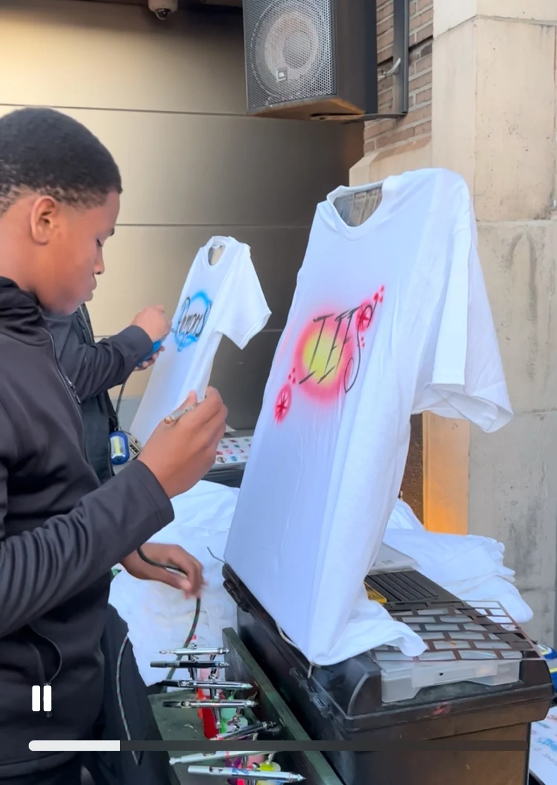 Airbrush artists customizing white T-shirts at the Target event in Philadelphia