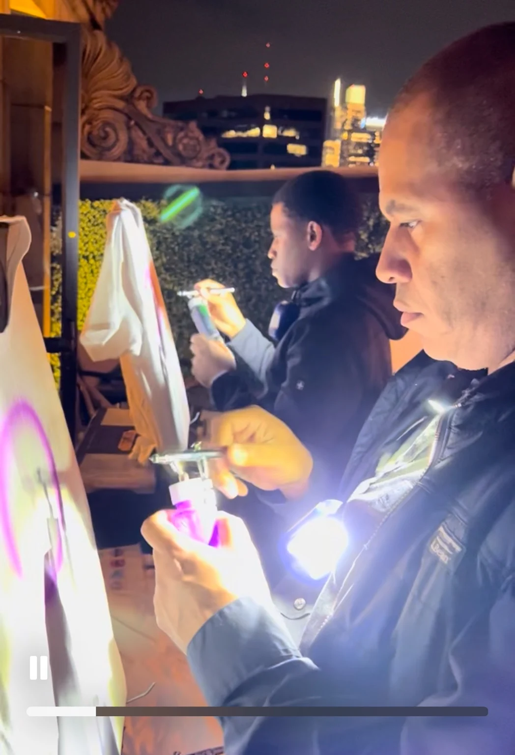 Two artists airbrushing T-shirts live at the Philadelphia event
