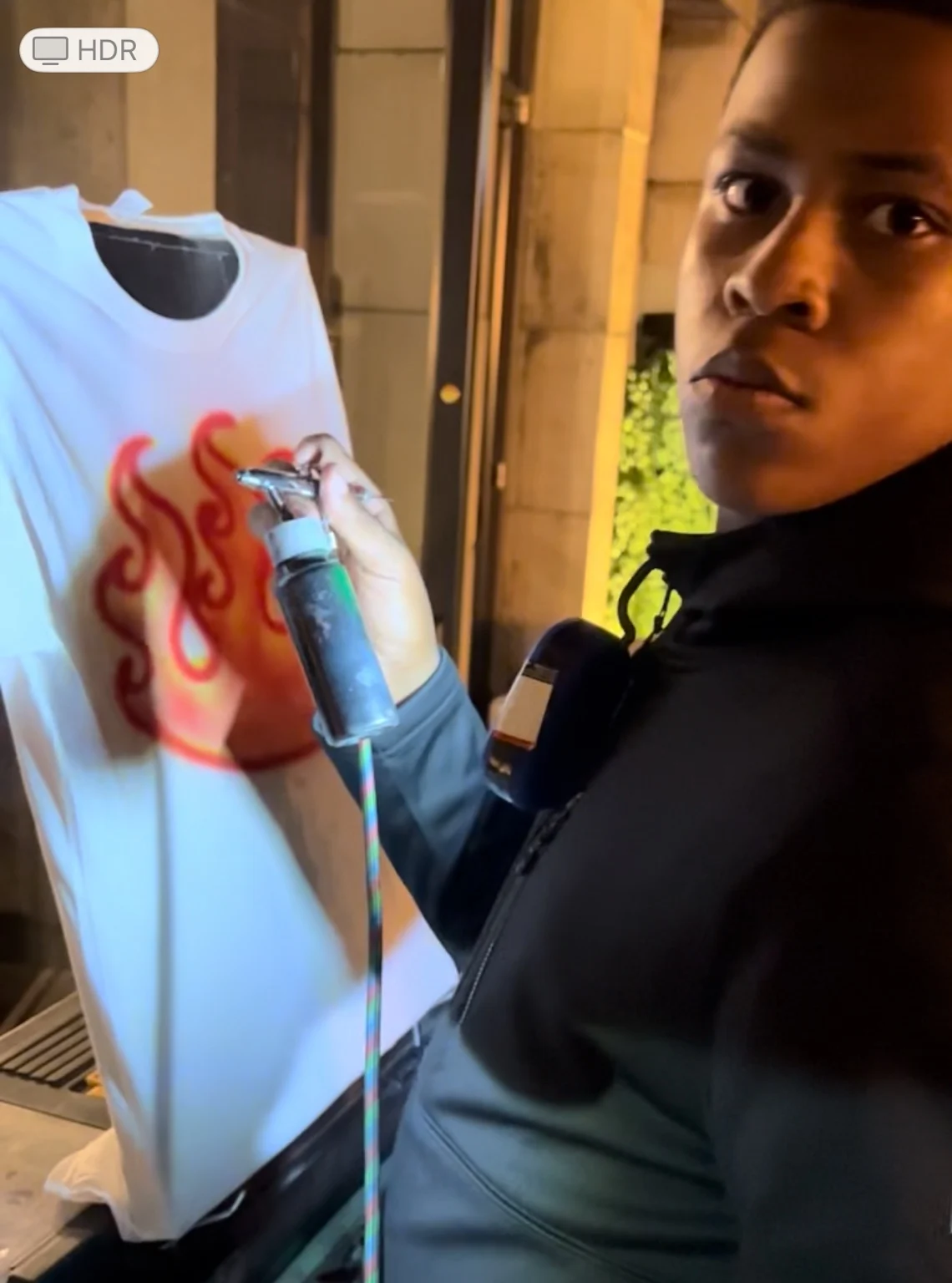 Artist creating a colorful flame design at the Target event