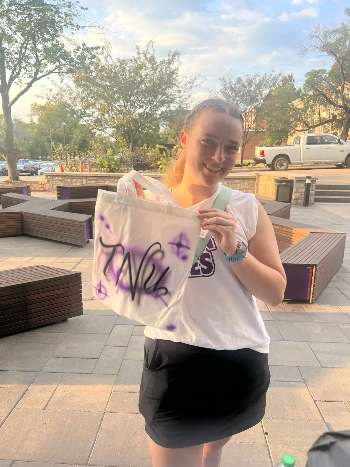 Trevecca student holding a personalized purple and black airbrushed canvas tote bag