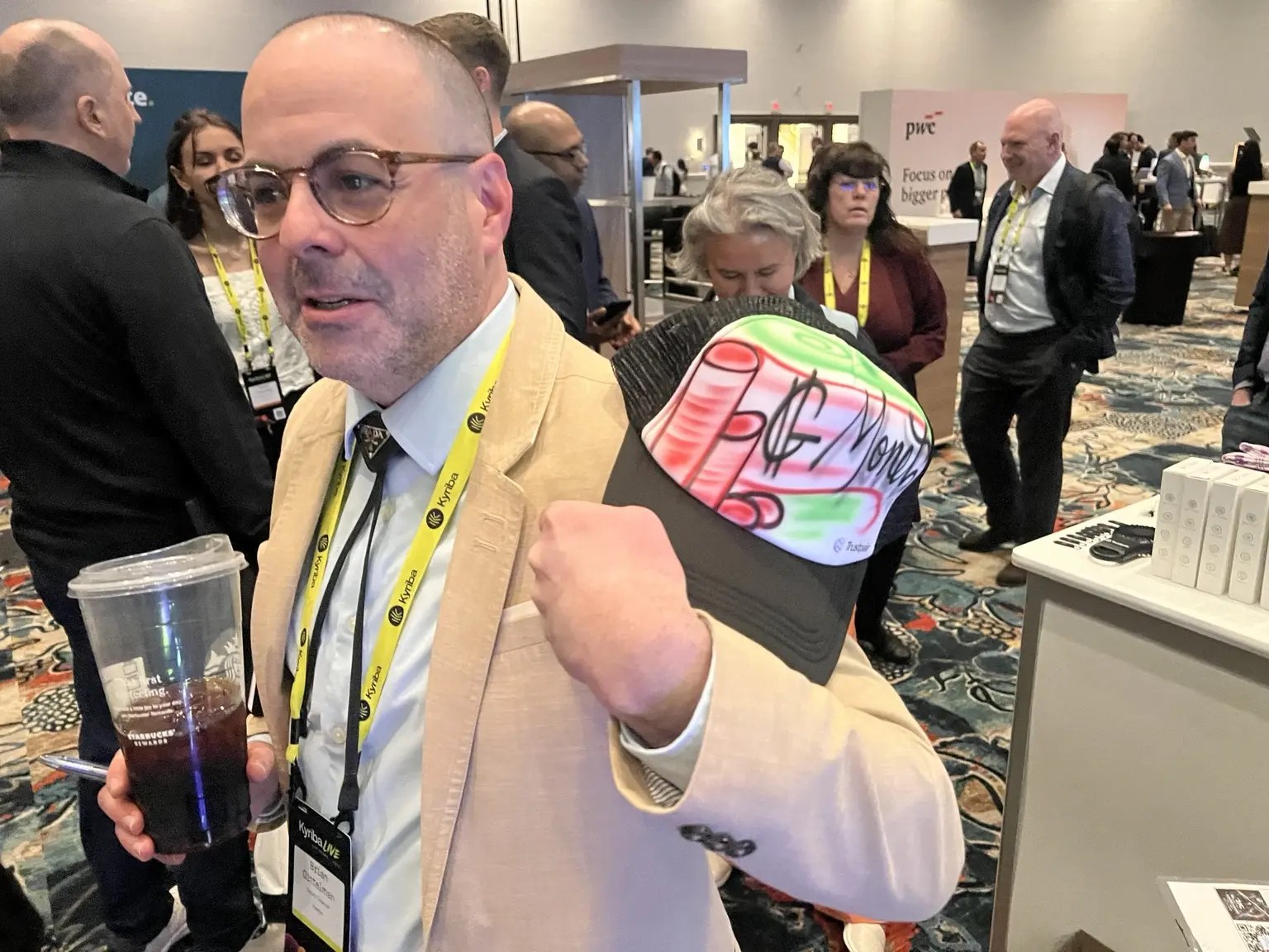 Trustpair conference attendee showing his personalized airbrushed hat