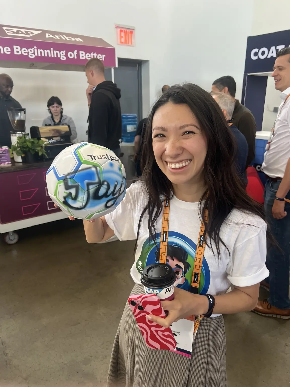 Smiling Trustpair guest holding a personalized blue soccer ball