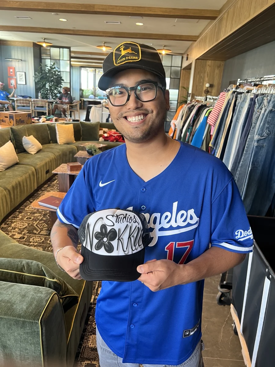 Guest displays a black and white personalized airbrush hat at the University of Tennessee event.