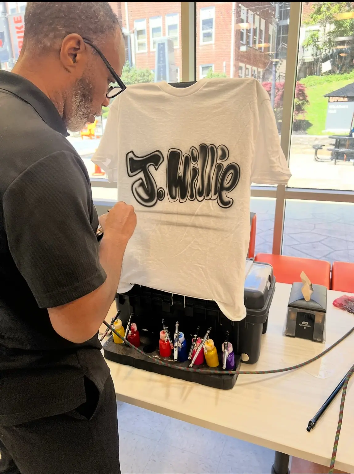 3JS artist painting a custom T-shirt live at the University of Pikeville