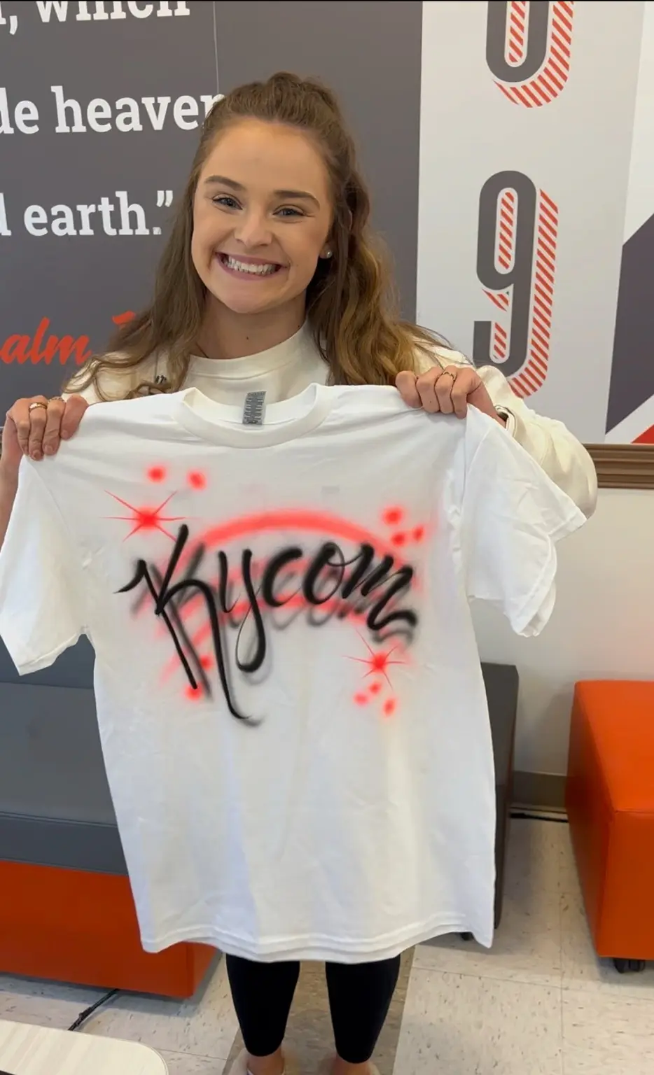 University of Pikeville student holding a personalized Bryce airbrushed T-shirt