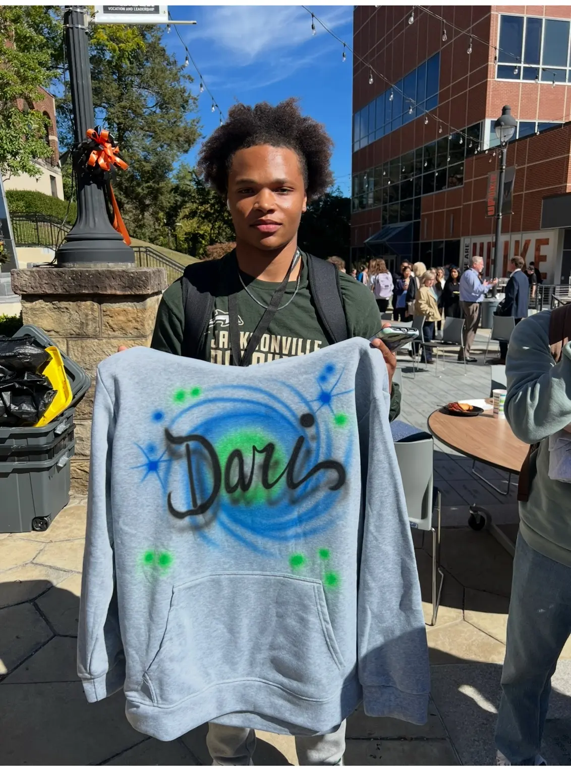 UPIKE student displaying a colorful personalized Dare airbrushed shirt