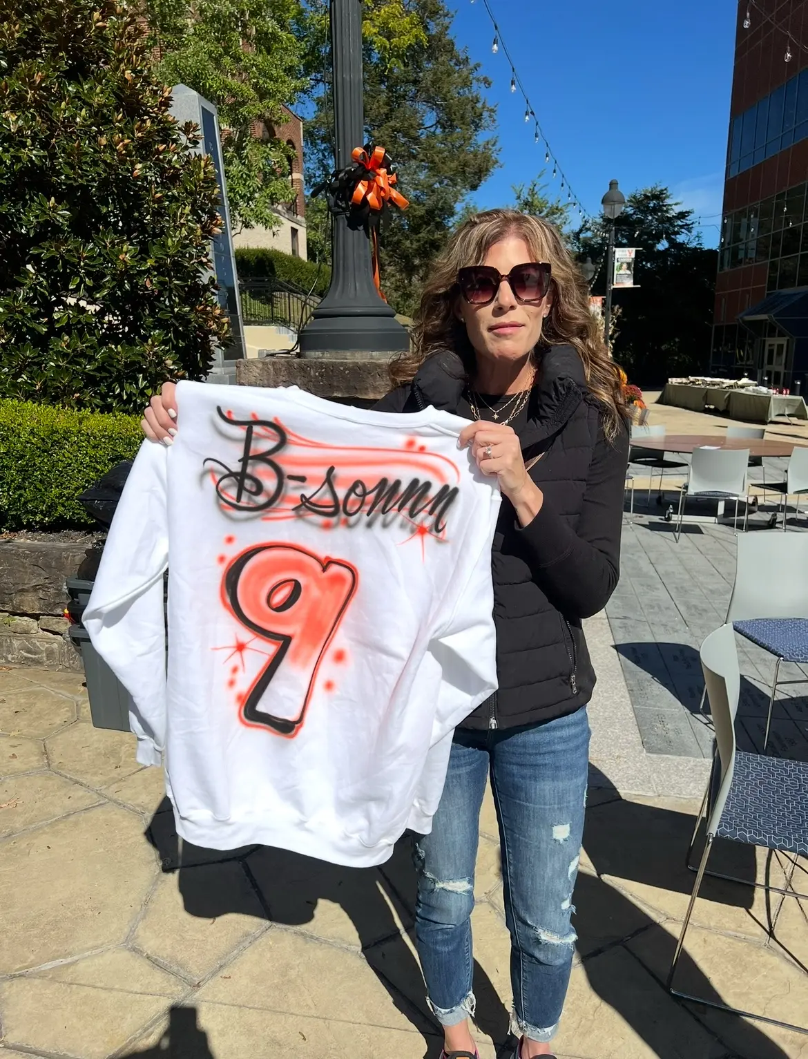 University of Pikeville student holding a personalized number nine airbrushed shirt