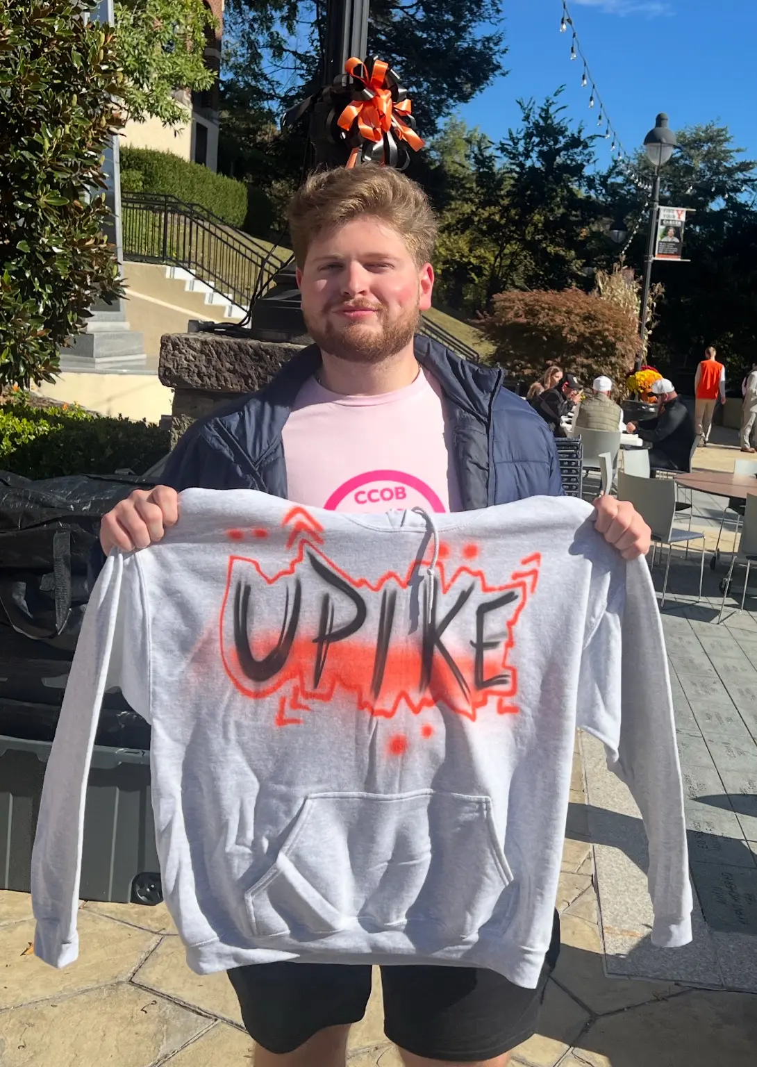 University of Pikeville student displaying a custom airbrushed UPIKE hoodie