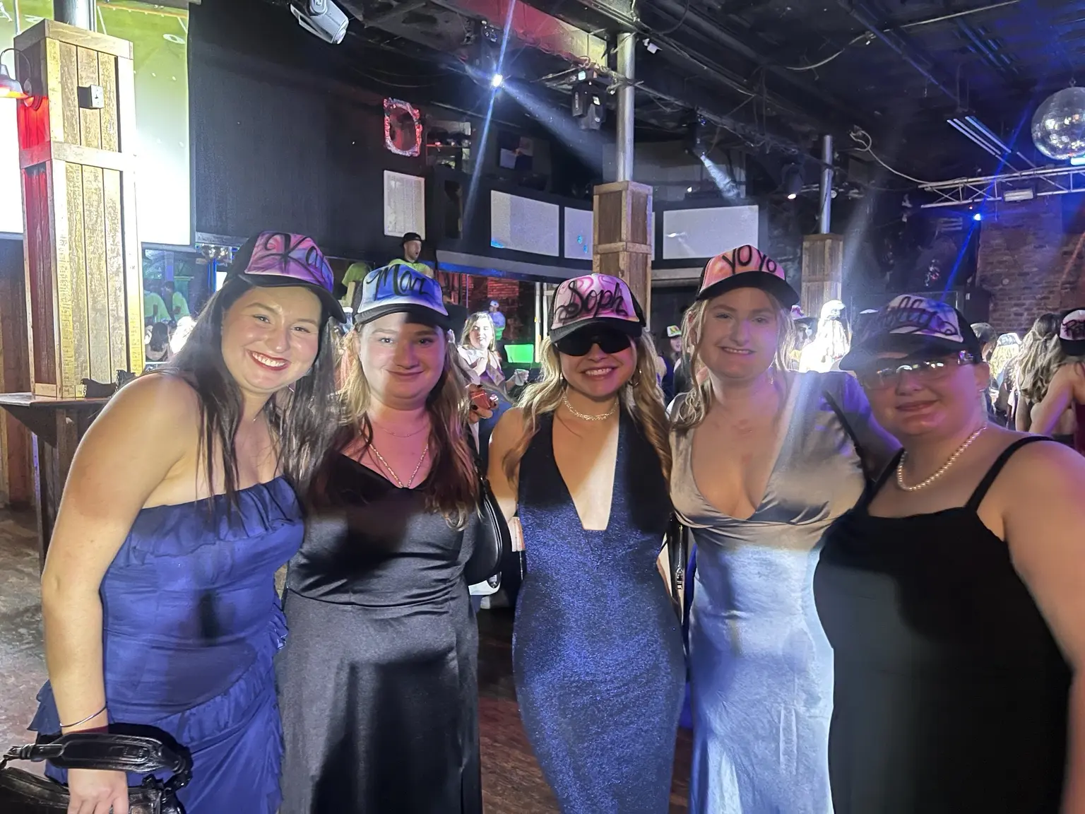 Friends at a University of South Carolina Delta Gamma event wearing airbrushed hats