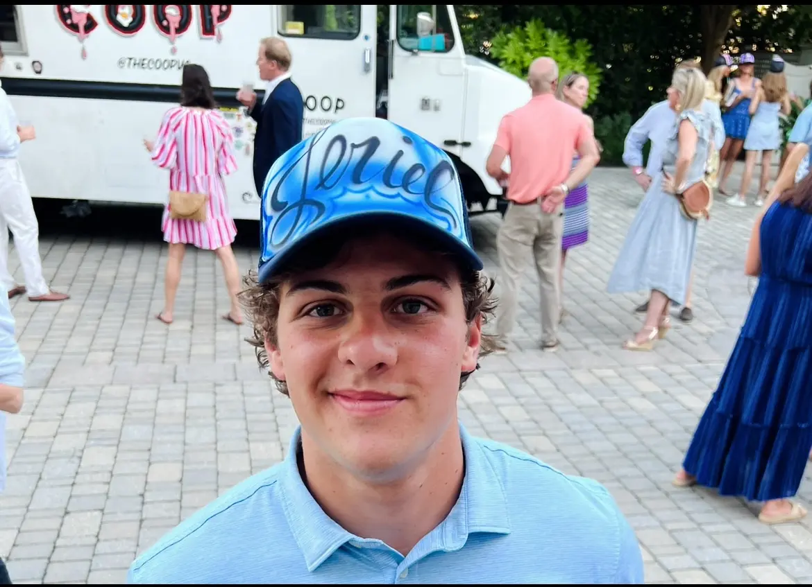Personalized name hat illustrating a live airbrush party favor